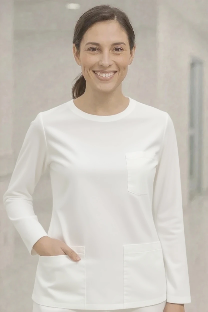 Woman wearing a white long-sleeve top with a neutral background