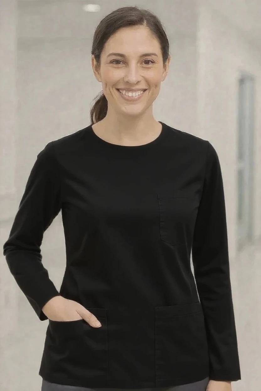 Woman wearing a black long-sleeve top with a neutral background