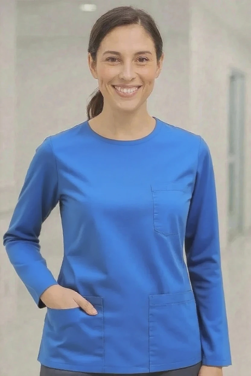 Person wearing a blue scrub top against a neutral background