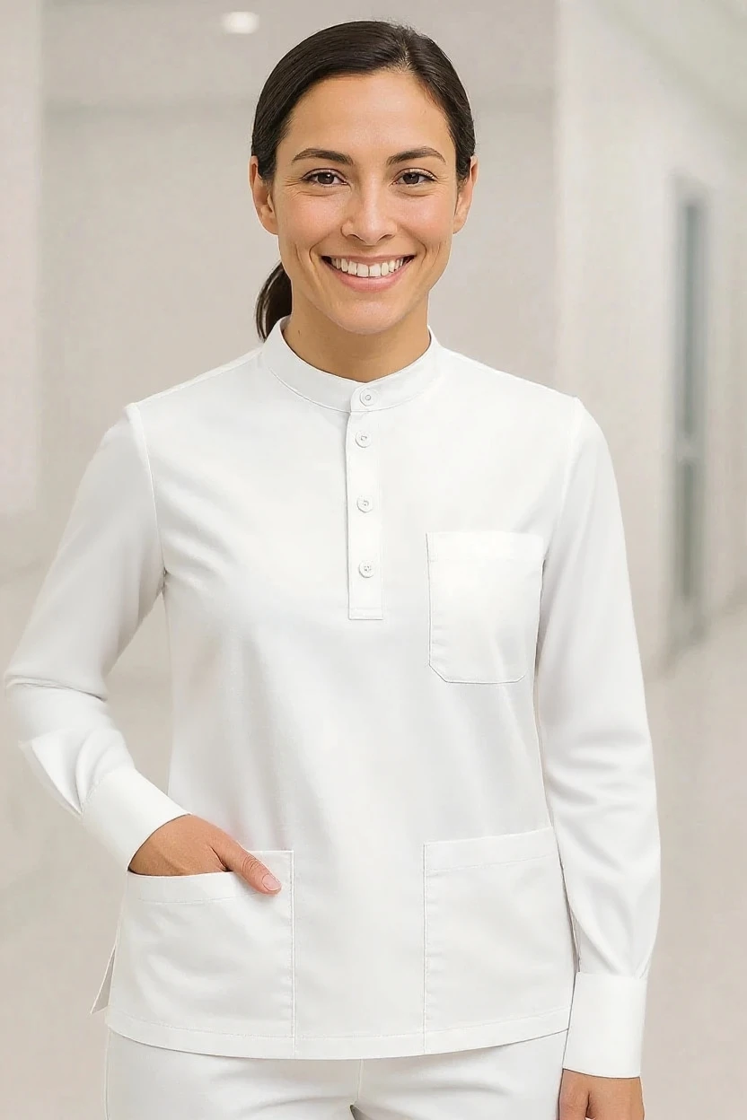 Person wearing a white long-sleeve shirt with a collar in a neutral setting
