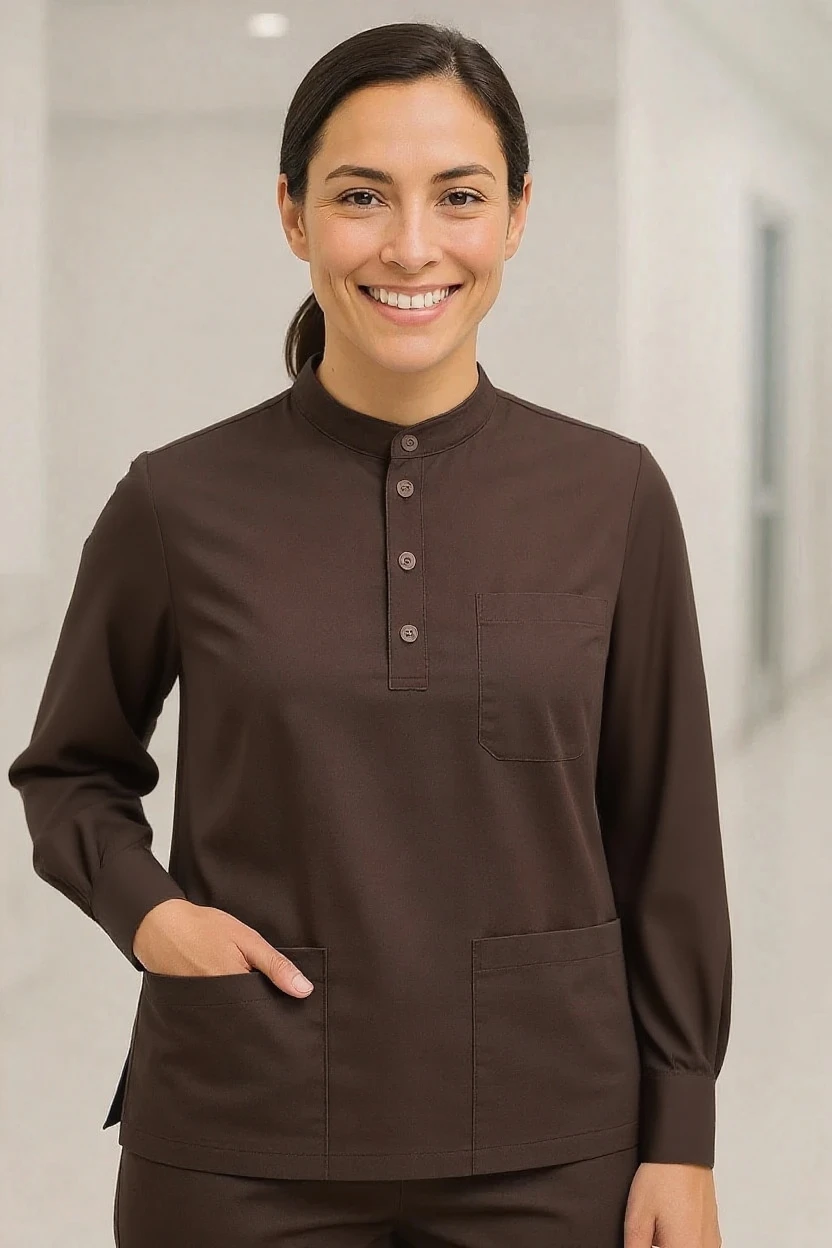 Woman wearing a brown long-sleeve shirt with a collar and buttons, standing against a neutral background.